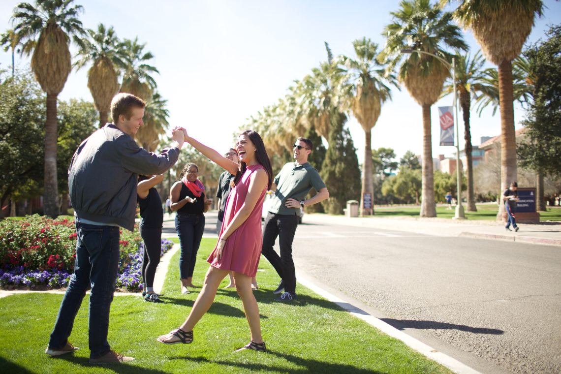 students laughing and smiling on UA main campus